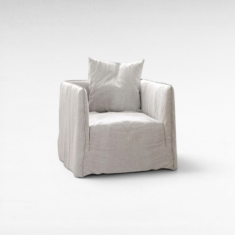 Chora Barefoot Luxury Living light grey linen armchair with loose slipcover and matching cushion.