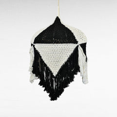Chora Barefoot Luxury Living handmade black and white macrame pendant light with fringe detail.