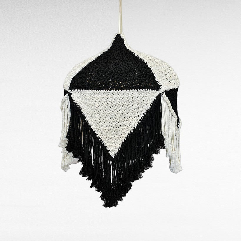 Chora Barefoot Luxury Living handmade black and white macrame pendant light with fringe detail.