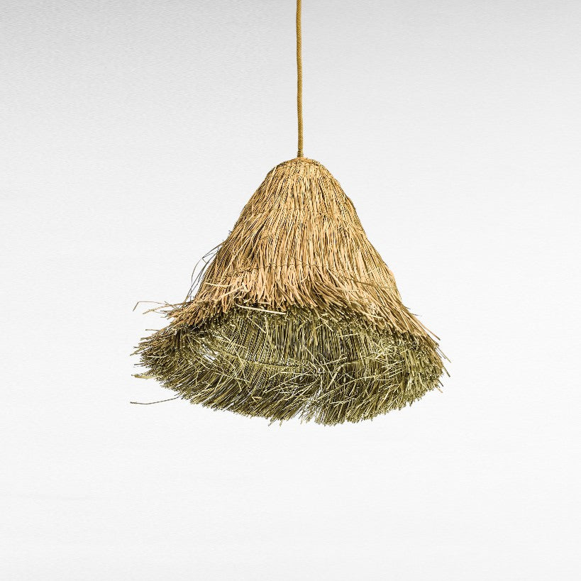 Chora Barefoot Luxury Living natural grass dome pendant lamp with a textured, layered weave in golden and green hues.