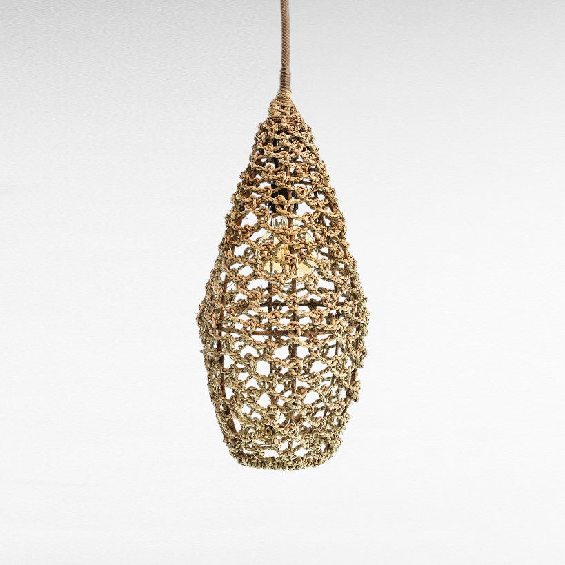 Chora Barefoot Luxury Living natural rattan pendant light with intricate weave and warm glow.