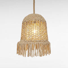 Chora Barefoot Luxury Living natural rope pendant light with fringe detail, bell shape, and warm illumination.