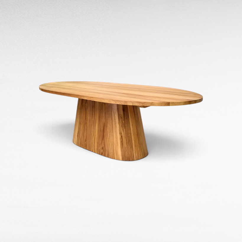 Chora Barefoot Luxury Living oval suar wood dining table with natural honey grain patterns and a solid pedestal base.