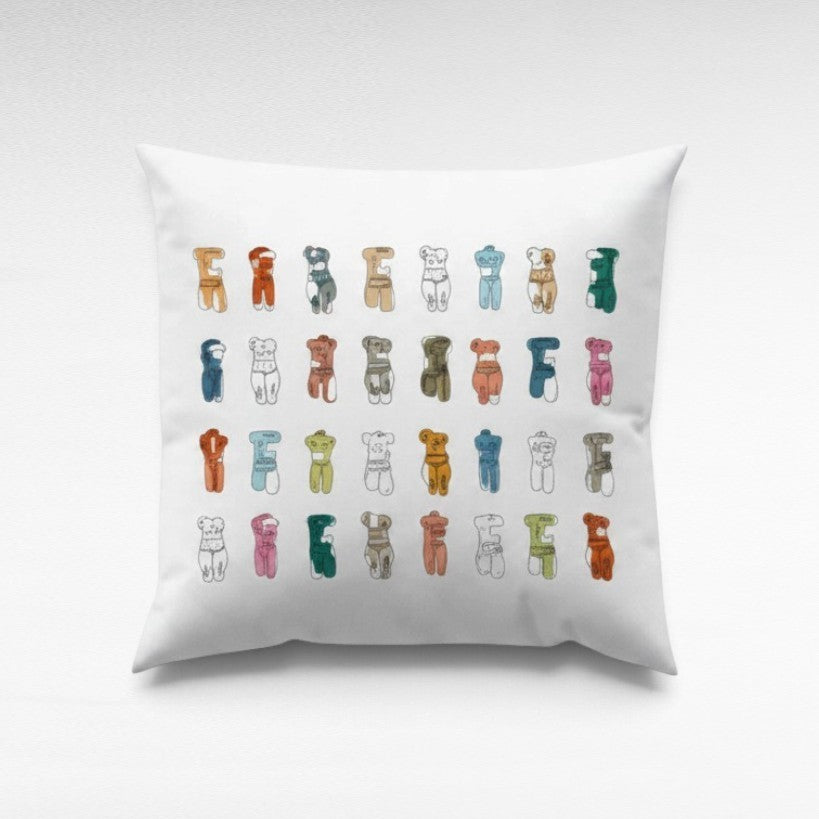Chora Barefoot Luxury Living square white pillow featuring a grid of colorful abstract human figure illustrations