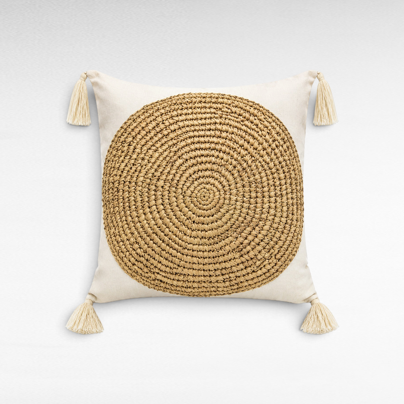 Chora Barefoot Luxury Living square white cushion with a natural round raffia center and decorative corner tassels