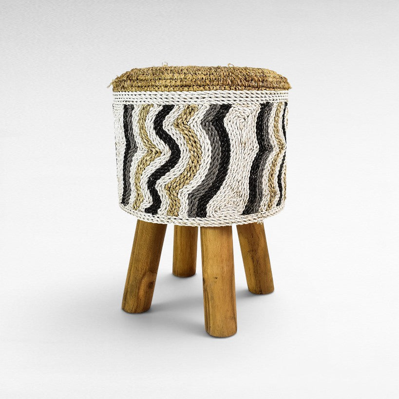 Chora Barefoot Luxury Living round stool with synthetic raffia, featuring a wavy black, white, and natural pattern.