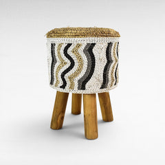Chora Barefoot Luxury Living round stool with synthetic raffia, featuring a wavy black, white, and natural pattern.