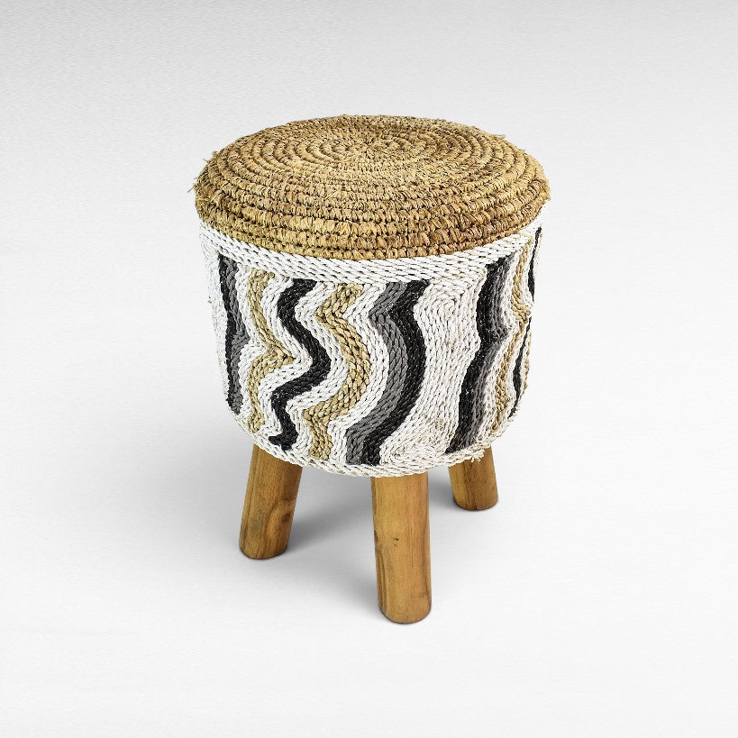 Chora Barefoot Luxury Living round stool with natural raffia top and white, black, and tan wavy synthetic rope base.