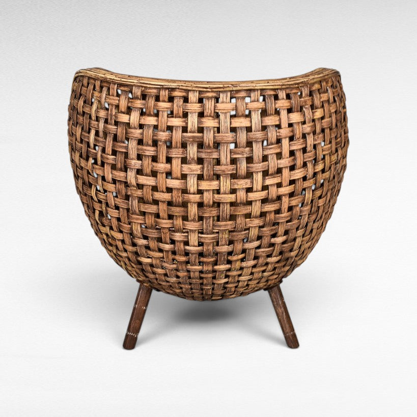 Chora Barefoot Luxury Living woven rattan chair with curved back and wooden legs, natural brown.