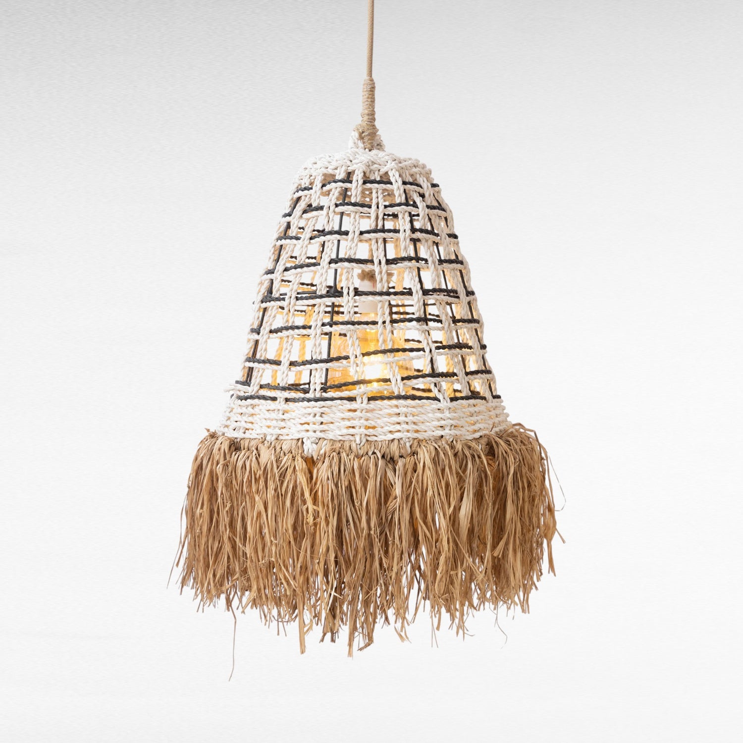 Chora Barefoot Luxury Living natural rattan and grass pendant light with fringe detail.