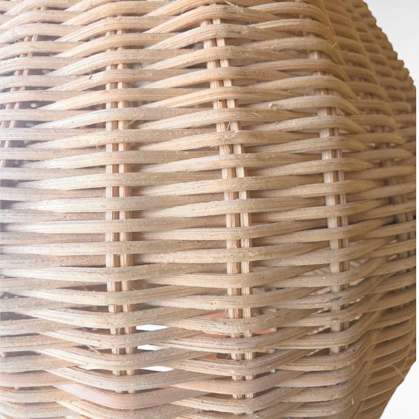 Chora Barefoot Luxury Living natural rattan oval pendant light with woven texture and cotton cord.