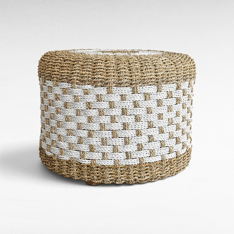 Chora Barefoot Luxury Living round stool made of woven natural and white synthetic rattan with a textured pattern.