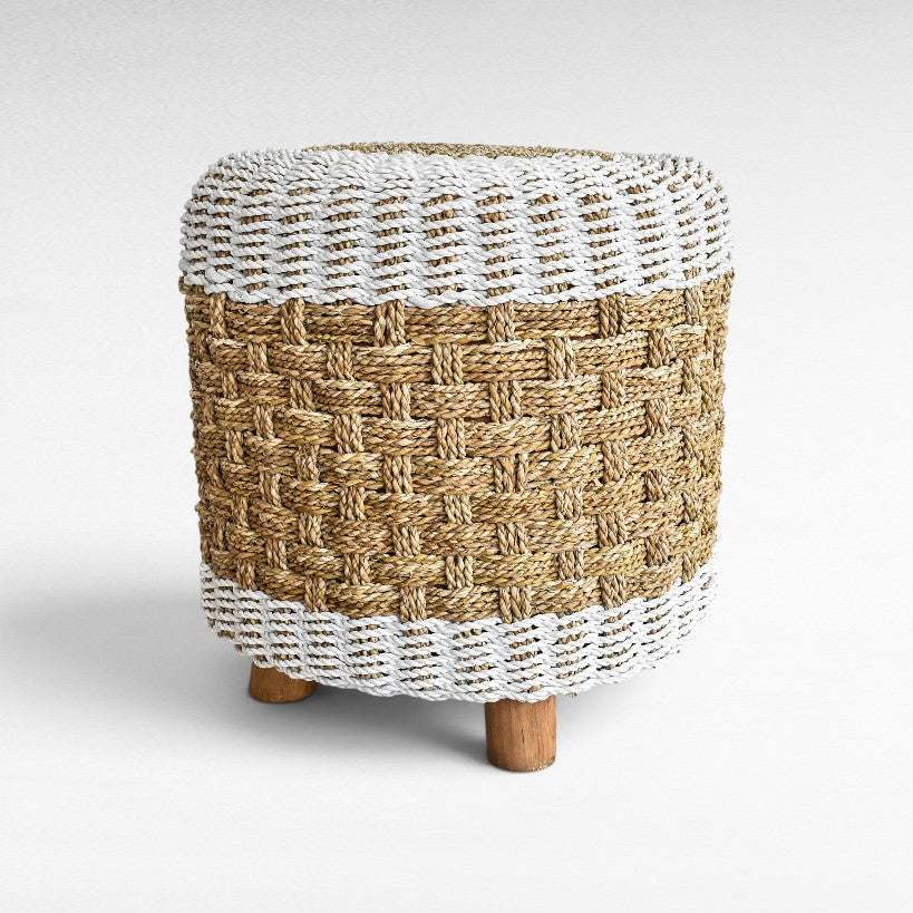 Chora Barefoot Luxury Living round stool featuring natural and white woven synthetic rattan with wooden legs.
