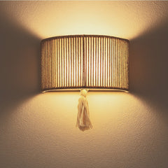Chora Barefoot Luxury Living natural cotton rope and metal frame wall lamp with tassel detail, 33cm wide.