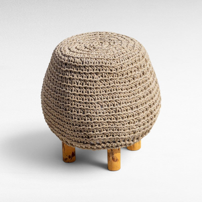 Chora Barefoot Luxury Living round natural rope stool with wooden legs, featuring a textured woven design.
