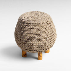 Chora Barefoot Luxury Living round natural rope stool with wooden legs, featuring a textured woven design.