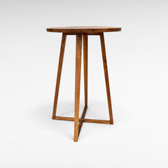 Chora Barefoot Luxury Living round wooden bar table with a minimalist design and sturdy cross-base legs.