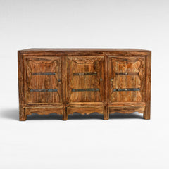 Chora Barefoot Luxury Living rustic wood buffet with three doors, metal accents, and carved details.