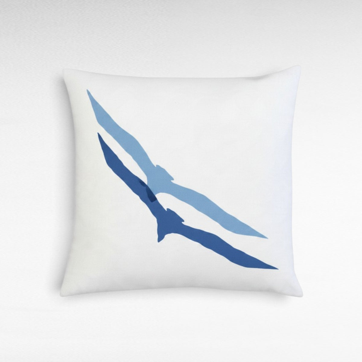 Chora Barefoot Luxury Living square white throw pillow featuring a minimalist blue seagull silhouette design.