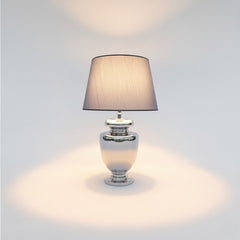 Chora Barefoot Luxury Living silver metal table lamp with grey fabric shade, ideal for modern living rooms or bedrooms.