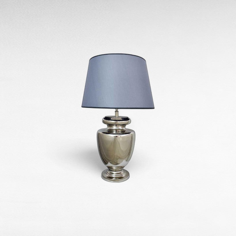 Chora Barefoot Luxury Living silver metal table lamp with a grey fabric shade and a polished metallic base.