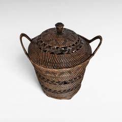 Chora Barefoot Luxury Living small dark brown woven rattan basket with a lid and decorative braided handle details