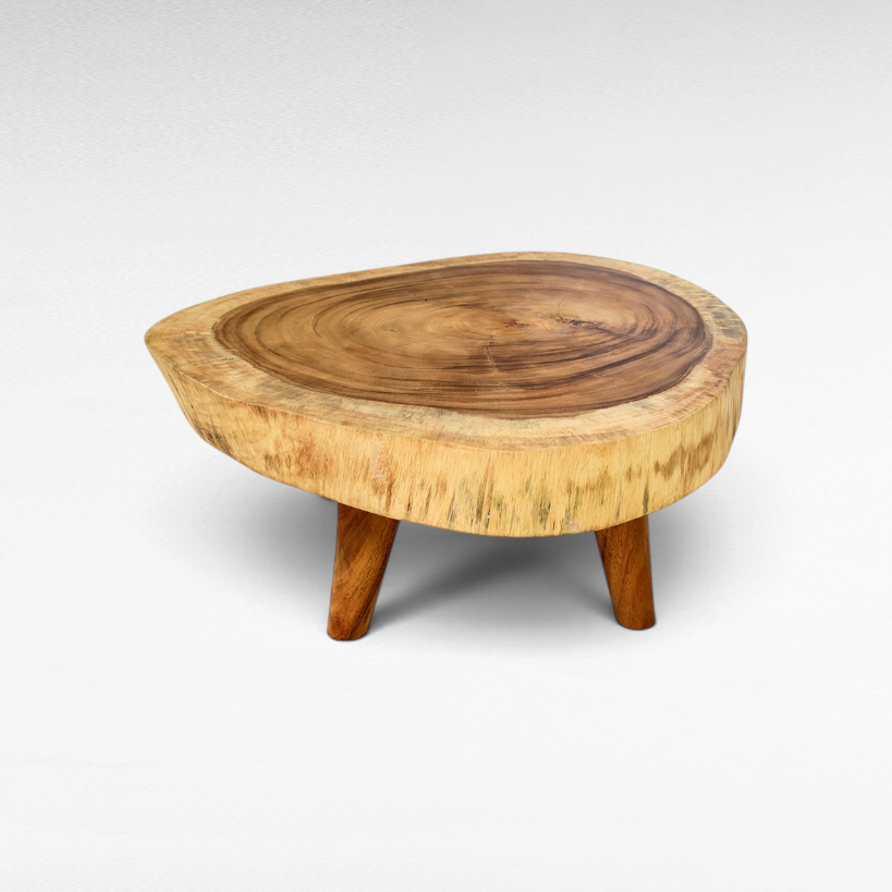 Chora Barefoot Luxury Living suar wood coffee table with a thick natural slab top and three angled wooden legs.