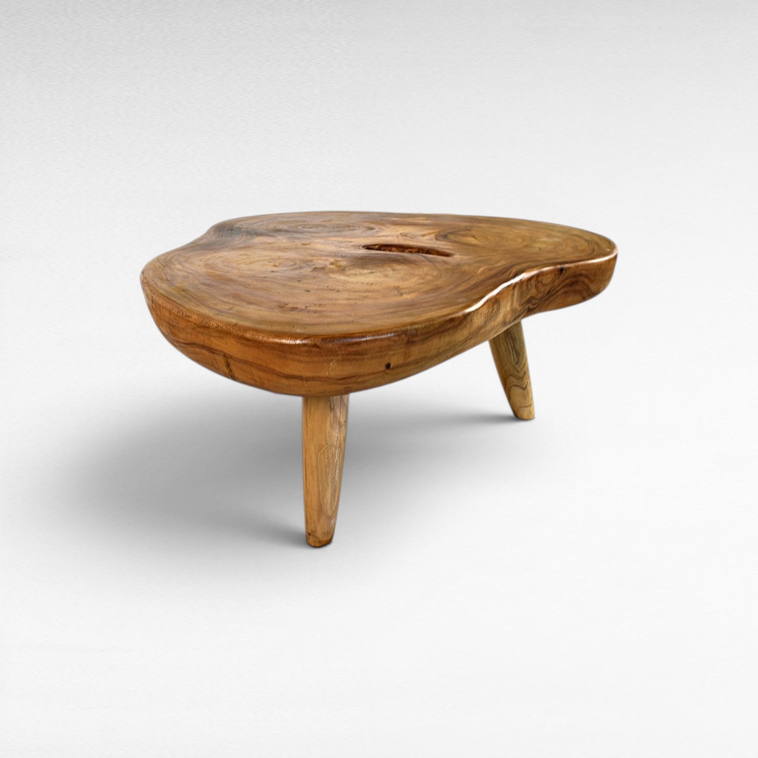 Chora Barefoot Luxury Living natural suar wood coffee table with organic grain patterns and honey tones. Unique, solid wood construction.