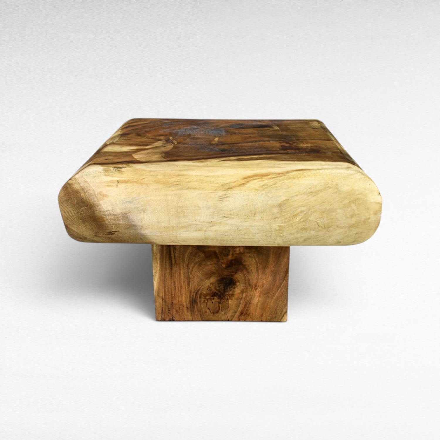 Chora Barefoot Luxury Living natural suar wood square coffee table with unique grain patterns and rounded edges.