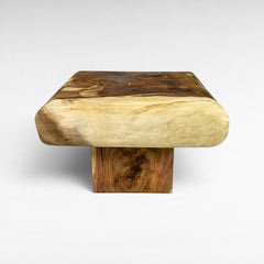 Chora Barefoot Luxury Living natural suar wood square coffee table with unique grain patterns and rounded edges.