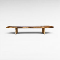 Chora Barefoot Luxury Living live edge suar wood dining table with natural wood grain and textured base.