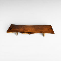 Chora Barefoot Luxury Living suar wood dining table with live edge, natural wood grain, and light stone legs. L510 D110 H80 cm.
