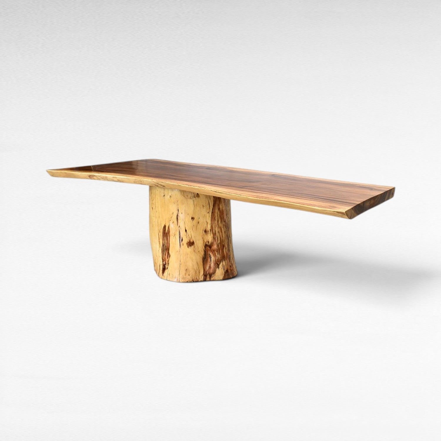 Chora Barefoot Luxury Living handcrafted suar wood dining table with natural grain patterns and a unique tree trunk base. Seats up to 10.