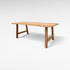 Chora Barefoot Luxury Living handcrafted suar wood dining table with natural live edge and sturdy trestle base