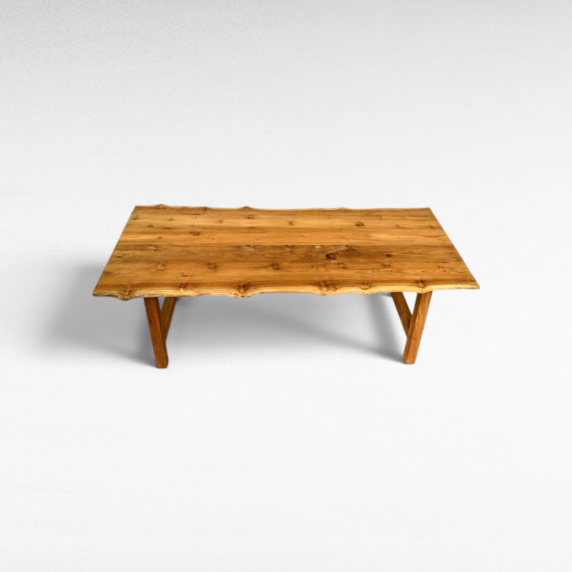 Chora Barefoot Luxury Living handcrafted suar wood dining table with natural live edge and rich wood grain patterns.
