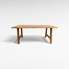 Chora Barefoot Luxury Living handcrafted suar wood dining table with natural live edge and organic grain patterns.