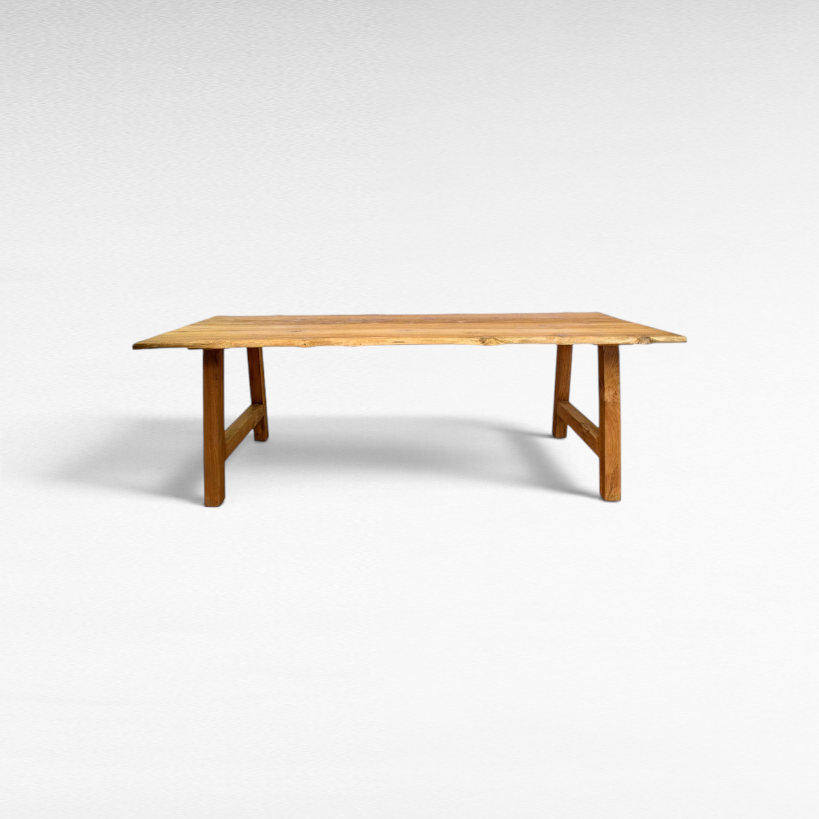 Chora Barefoot Luxury Living handcrafted suar wood dining table with natural organic edges and rich grain patterns.