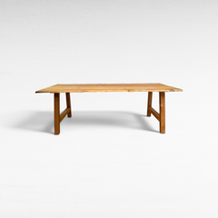 Chora Barefoot Luxury Living handcrafted suar wood dining table with natural organic edges and rich grain patterns.