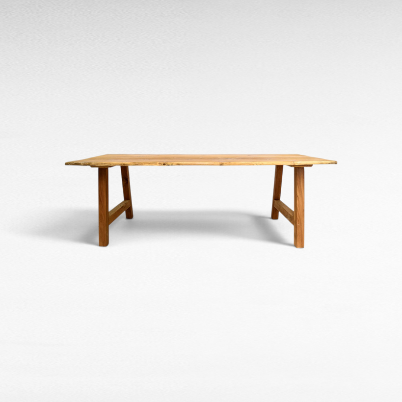 Chora Barefoot Luxury Living handcrafted suar wood dining table with natural organic live edges and solid wood legs.