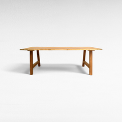 Chora Barefoot Luxury Living handcrafted suar wood dining table with natural organic live edges and solid wood legs.