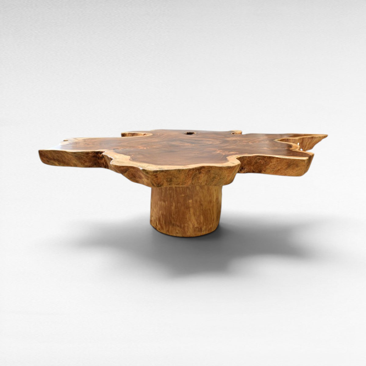 Chora Barefoot Luxury Living suar wood table with a star shape, natural wood grain, and pedestal base.