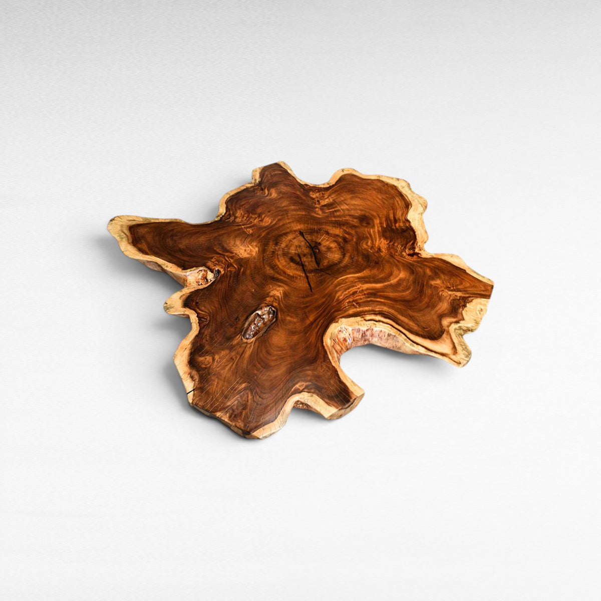 Chora Barefoot Luxury Living suar wood table top, star-shaped with natural live edge and intricate grain patterns.