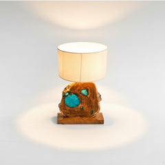 Chora Barefoot Luxury Living teak wood and blue resin table lamp with a natural wood base and beige drum shade.