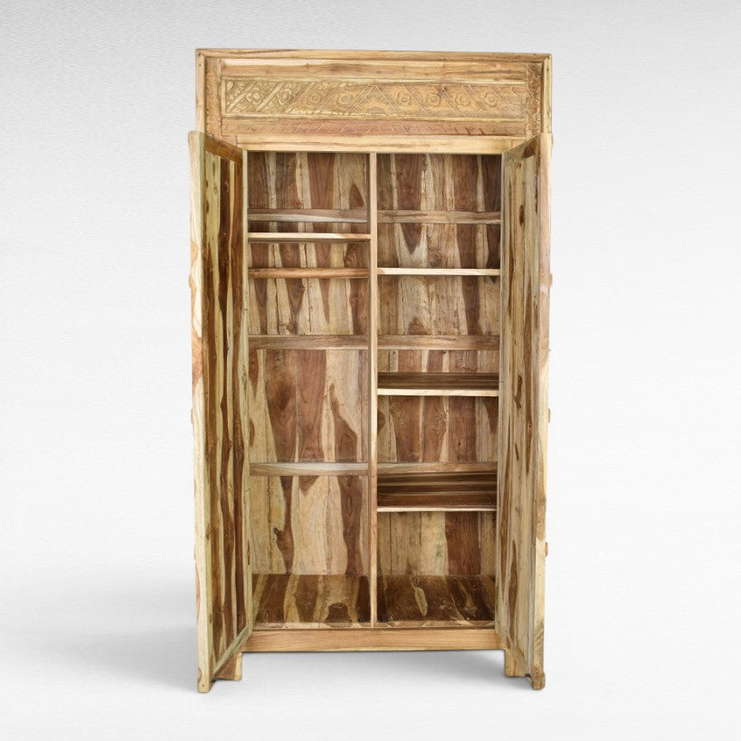 Chora Barefoot Luxury Living carved teak wood cabinet with open doors, natural wood finish, multiple shelves.