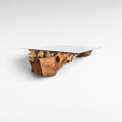 Chora Barefoot Luxury Living dining table with a natural teak wood root base and a clear rectangular glass top