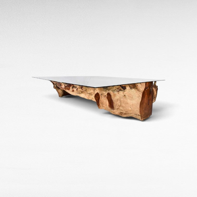 Chora Barefoot Luxury Living teak wood dining table with a clear glass top and natural organic wood base
