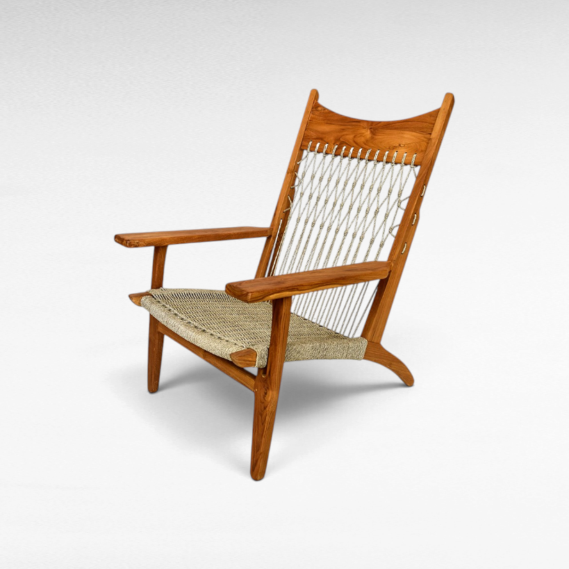Chora Barefoot Luxury Living teak wood armchair with a woven synthetic raffia seat and decorative knotted backrest.