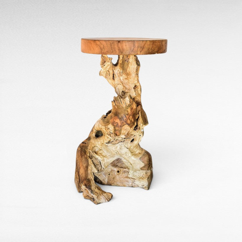 Chora Barefoot Luxury Living natural teak wood stool with a rustic organic root base and smooth circular top