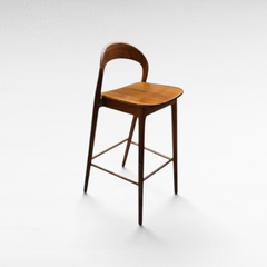 Chora Barefoot Luxury Living teak wood bar stool with a curved backrest and minimalist design on a white background