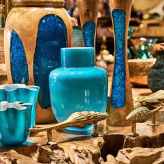 Chora Barefoot Luxury Living teak wood candle holder with blue resin inlay, natural wood grain, and unique artistic design.